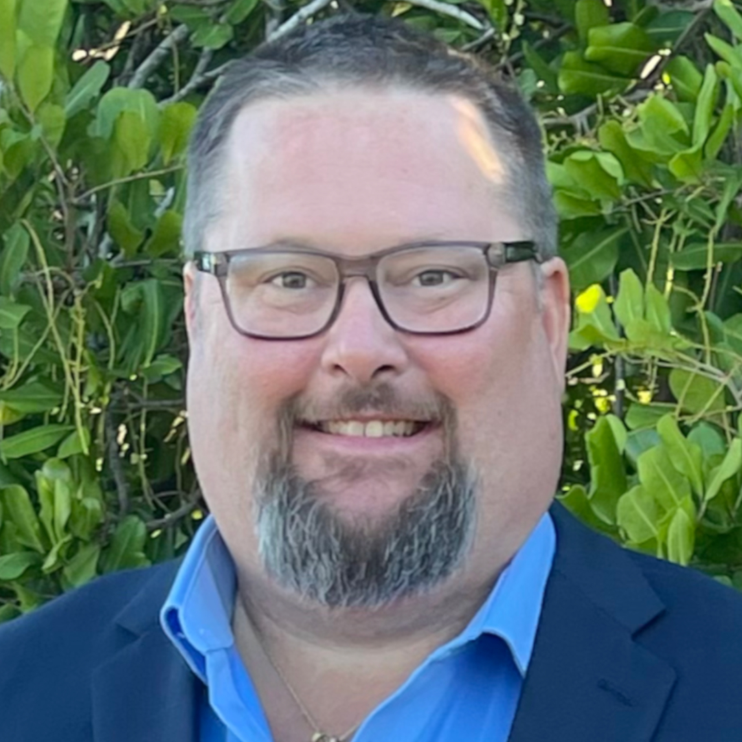 A professional portrait of Timothy Schwan, an environmental specialist with a deep connection to Florida's natural ecosystems. Tim stands confidently, reflecting his expertise and passion for environmental preservation and sustainable progress. The background subtly evokes Florida’s landscapes, with hints of water and greenery, emphasizing his lifelong dedication to protecting the environment.